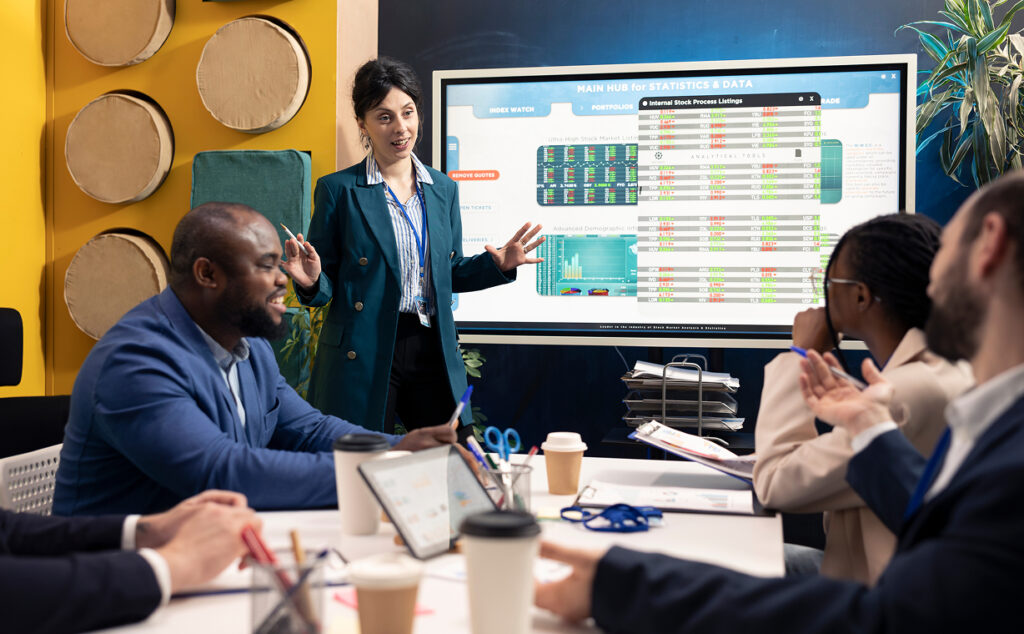 A group of people having a meeting, where they are talking about analytics and data